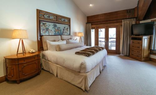 a bedroom with a large bed and a television at Luxury King Room Hotel Room in Park City