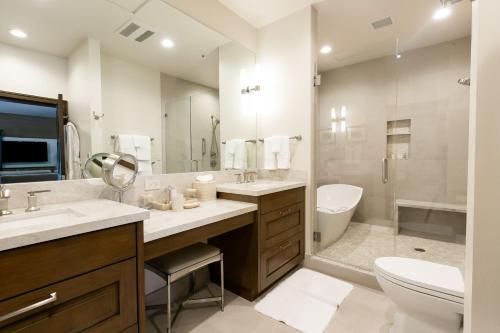 a bathroom with two sinks and a toilet and a tub at Sterling Studio Hotel Room in Park City