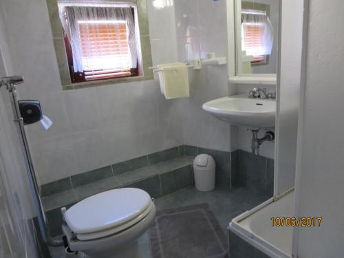 a bathroom with a toilet and a sink at Secluded house with a parking space Beli, Cres - 13893 in Beli