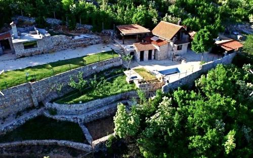 an aerial view of a house with a stone wall at Family friendly house with a swimming pool Zagvozd, Zagora - 13901 in Zagvozd