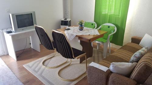 a living room with a table with chairs and a tv at Apartments with a parking space Rudina, Hvar - 13903 in Stari Grad
