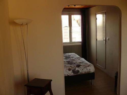 a small bedroom with a bed and a window at Auberge Fleurie in Saint-Nizier-sur-Arroux