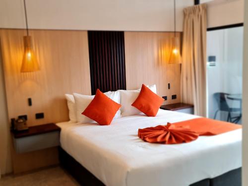 Un dormitorio con una cama blanca con un arco naranja. en Brijag Apartments, 