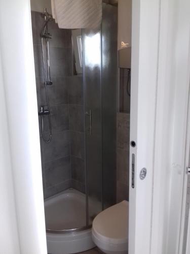 a bathroom with a shower and a toilet at Apartments with a parking space Slatine, Ciovo - 13922 in Slatine