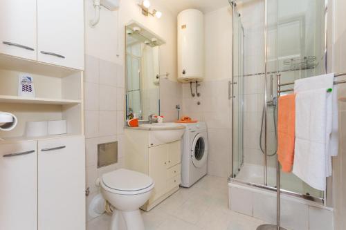 a bathroom with a toilet sink and a shower at Apartments with WiFi Split - 13957 in Split