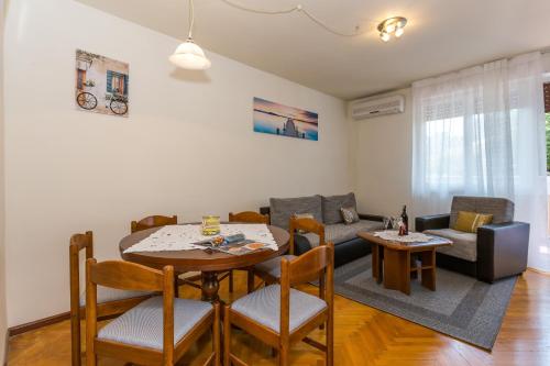 a living room with a table and a couch at Apartments with WiFi Split - 13957 in Split