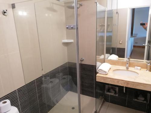 a bathroom with a shower and a sink at Apart Peru II in Lima