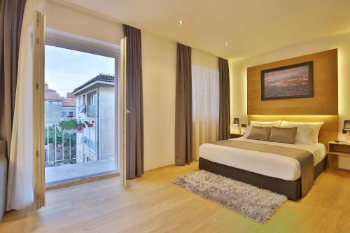 a bedroom with a bed and a large window at Rooms by the sea Zadar - 14007 in Zadar