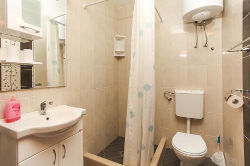 a bathroom with a toilet and a sink and a shower at Studio Lopud 14013a in Lopud Island
