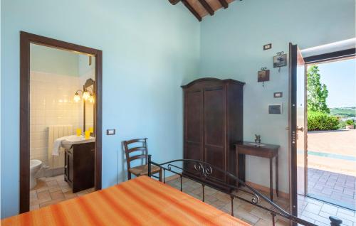 a bedroom with a bed and a bathroom with a door at Lovely Home In Tolentino With Kitchen in Tolentino