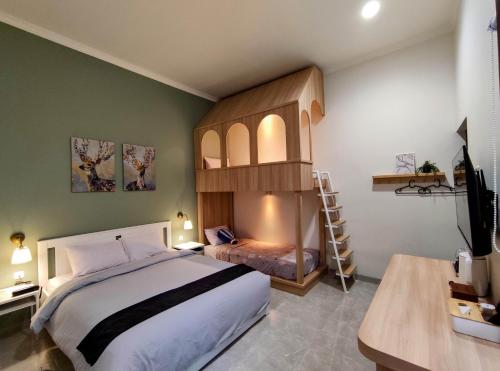 a bedroom with a large bed and a loft bed at Cottonwood Boutique Heritage Otten in Bandung
