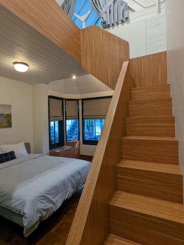 a bedroom with a bed and a staircase at Cottonwood Boutique Heritage Otten in Bandung