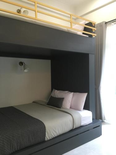 a bed with white sheets and pink pillows in a bedroom at Cottonwood Boutique Heritage Otten in Bandung