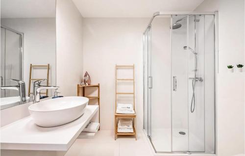 a white bathroom with a sink and a shower at Amazing Apartment In Mrzezyno With Wifi in Mrzeżyno