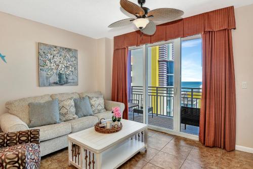 a living room with a couch and a table at Modern Beach Highrise-Ocean View-Jacuzzi-Walk In Shower At Ocean Walk Resort Daytona Beach in Daytona Beach