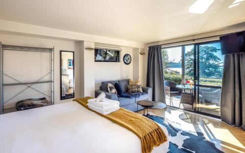 a bedroom with a large bed and a living room at Aqua Sands #2 in Oneroa