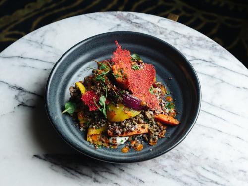 a black bowl of food on a table at Fable Christchurch in Christchurch