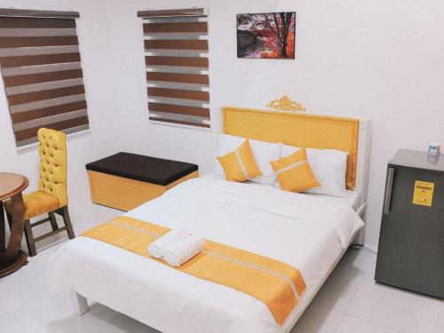 a bedroom with a large bed and a chair at Villa Excellance Beach and Wave Pool Resort in Postema
