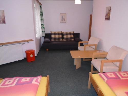 a living room with two beds and a couch at Pension Dobroucky in Prague