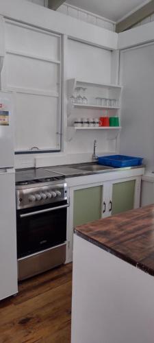 a kitchen with a stove and a counter top at Gingerbread Cottage and Studio Fiji in Savusavu