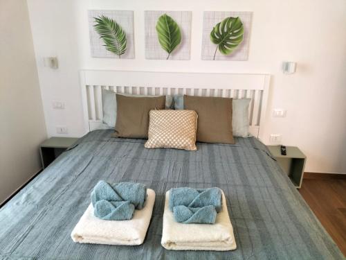 a bedroom with a bed with two towels on it at Appartamenti MiNuMa Tropea in Tropea