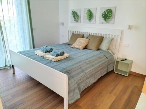 a bedroom with a bed with a camera on it at Appartamenti MiNuMa Tropea in Tropea