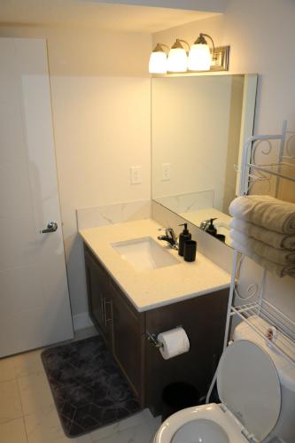 a bathroom with a sink and a mirror at Guest Suite in Calgary in Calgary