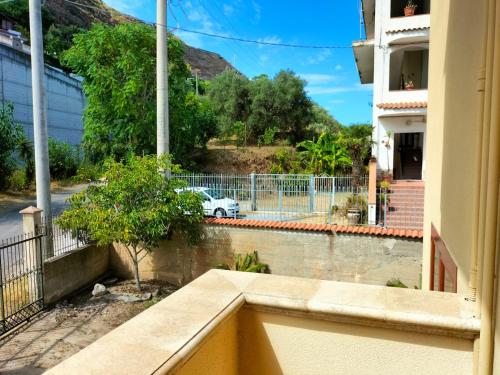 a view from the balcony of a building with a car at Appartamenti MiNuMa Tropea in Tropea
