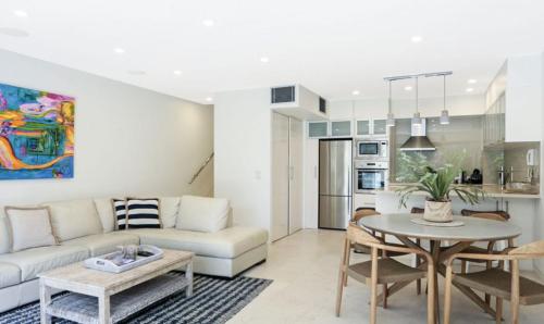 a living room with a couch and a table at Little Cove Court - Apt 4 in Noosa Heads