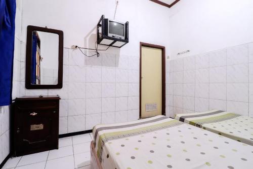 Postel nebo postele na pokoji v ubytování Hotel Gajah Mada