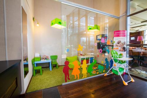 a room with a window with a play room with toys at Qubus Hotel Kraków in Kraków