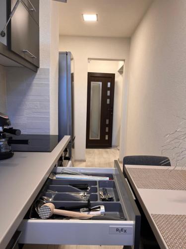 a drawer in a kitchen withtools in it at Barney Apartman in Sovata