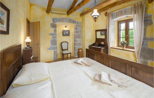 a bedroom with a large bed with two towels on it at Beautiful Home In Krbune With Wifi in Krbune