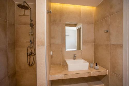 a bathroom with a sink and a shower at Ossiano Pool Villas,Heating Pool, 2 min drive to Haraki Beach & 10 min to Lindos in Haraki