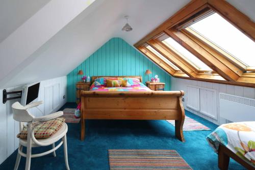 a bedroom with a bed in a attic at Western House in Llangennith