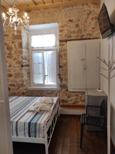 a bedroom with a bed and a window at 1830 Chateau in Nafplio