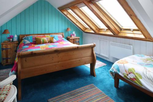 a bedroom with a bed and a skylight at Western House in Llangennith