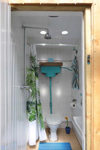 a bathroom with a toilet and a sink and a tub at The Bake House in Llangennith
