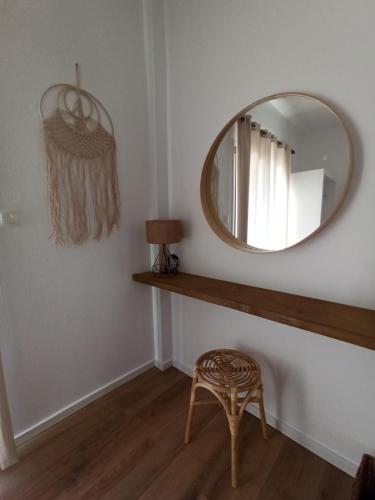 a mirror and a stool in a room at Harmony in Poros