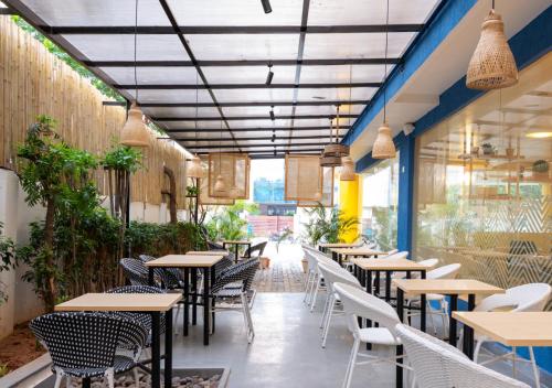 a row of tables and chairs in a restaurant at Bloom Hotel - HITEC City in Hyderabad