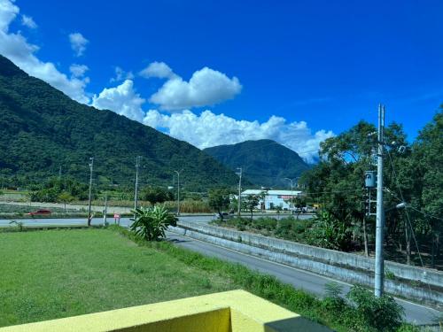 a view of a road with mountains in the background at 太魯閣惠宇民宿 in Xincheng