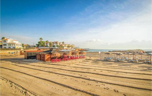 a beach with chairs and umbrellas and the ocean at Cozy Apartment In Torrevieja With Wifi in Torrevieja