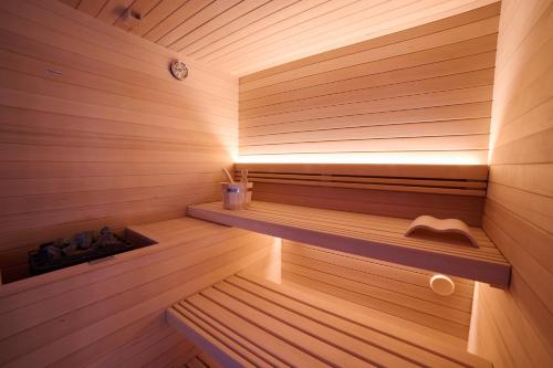 a sauna with a bench in a wooden room at Ludwig Boutique Hotel & Spa in Bolsena