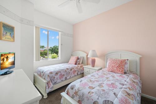 a bedroom with two beds and a window at Vista Verde North 5-231, 2 Bedrooms, Sleeps 6, Golf View, Heated Pool, Spa, WiFi in St. Petersburg