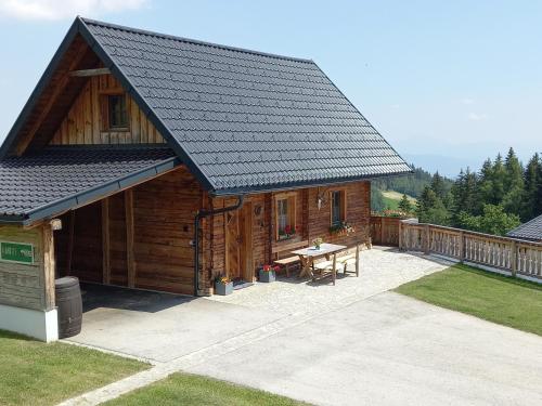 a log cabin with a picnic table in front of it at Almchalet Schuster in Diex