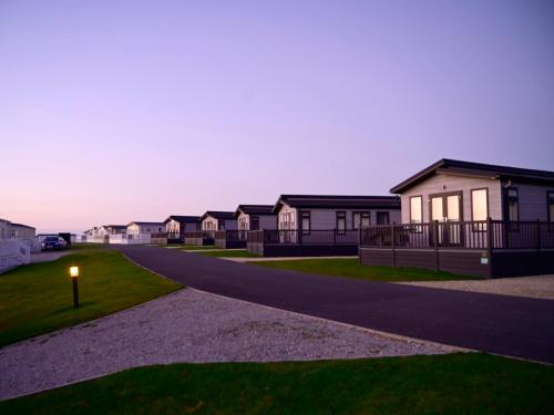 a row of houses on a street at dusk at Rose View in Newquay