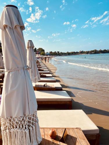 a row of tables with umbrellas on the beach at Kalia Beach Hotel Side in Side