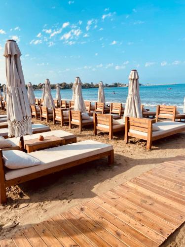 a row of chairs and umbrellas on a beach at Kalia Beach Hotel Side in Side