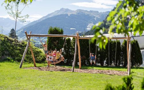 a group of children playing on a swing at Hotel Lener in Vipiteno