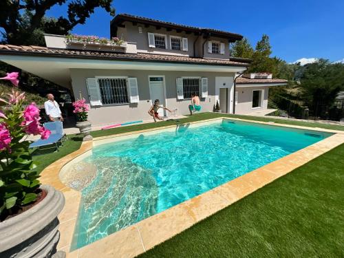 a swimming pool in the yard of a house at B&B LE TERME in Rivanazzano